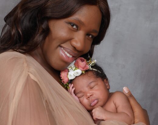 mother holding new baby transition to 4 kids